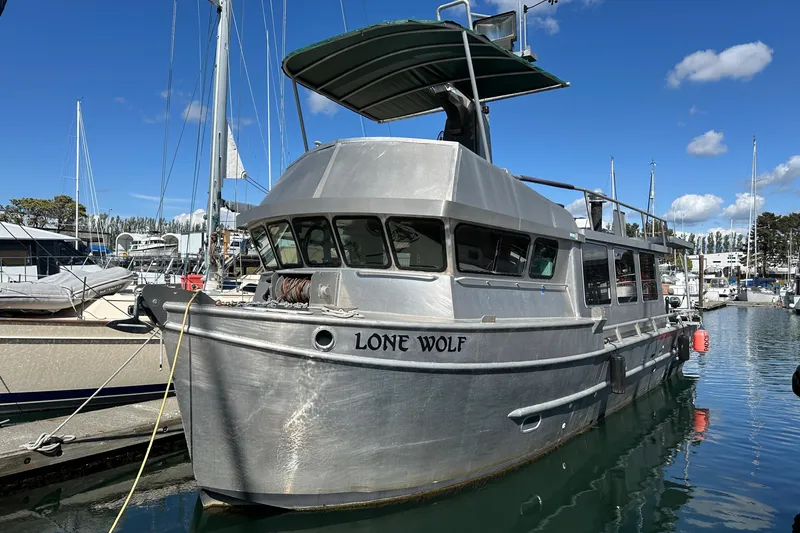 Slide: The Image of Custom 2002 Carlson Marine Trawler "Lone Wolf" docked in marina under blue sky. - 46