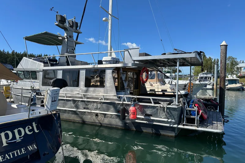 Slide: The Image of Custom 2002 Carlson Marine Trawler docked at marina under clear blue sky. - 47