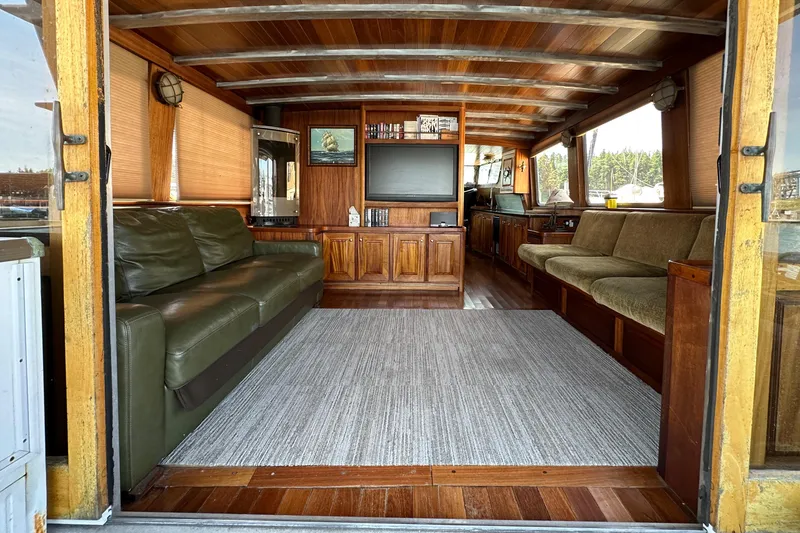 Slide: The Image of Interior of 2002 Carlson Marine Trawler with wooden decor and comfortable seating. - 7