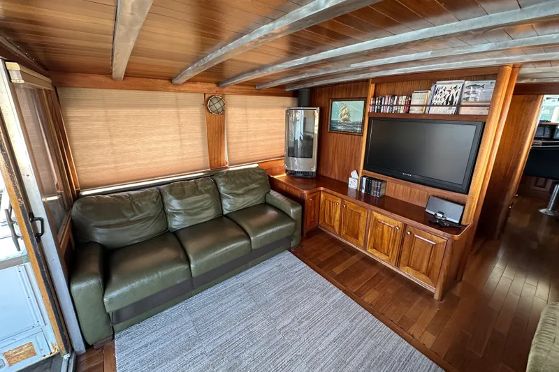 Slide: The Image of Luxurious interior of 2002 Carlson Marine Trawler with leather sofa and entertainment center. - 8