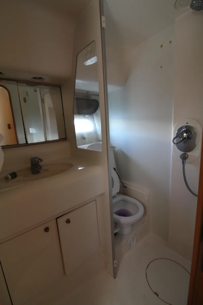 Slide: The Image of Bathroom interior of 1997 Viking Sport Cruisers 48SC yacht, featuring shower and toilet. - 13