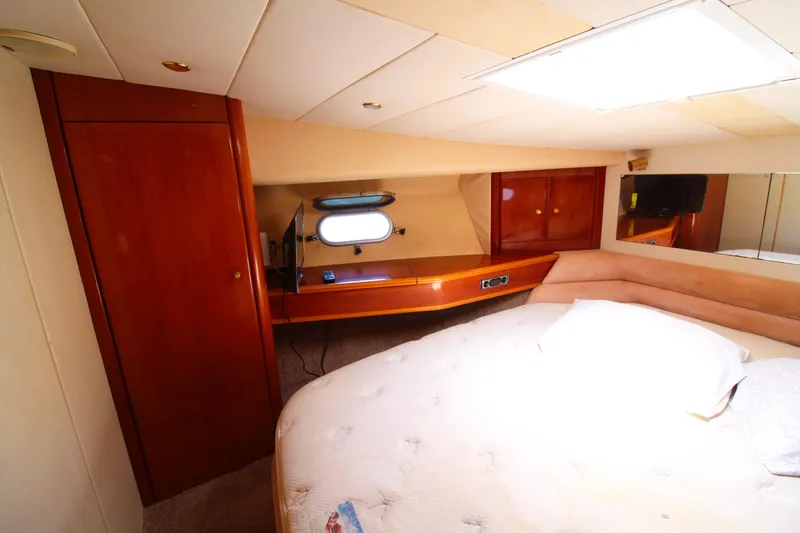 Slide: The Image of Luxurious cabin interior of 1997 Viking Sport Cruisers 48SC yacht with cozy bed and wooden accents. - 14