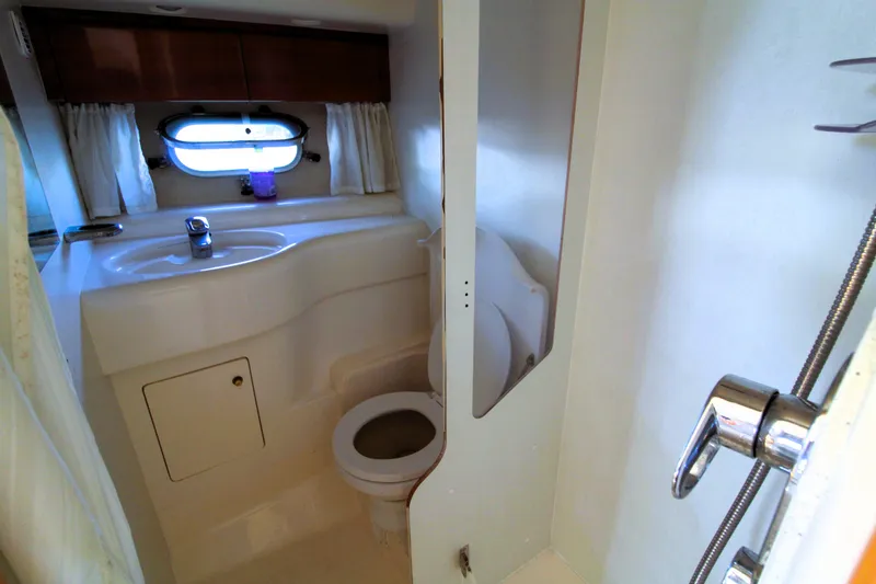 Slide: The Image of Bathroom interior of 1997 Viking Sport Cruisers 48SC yacht, featuring sink and toilet. - 17