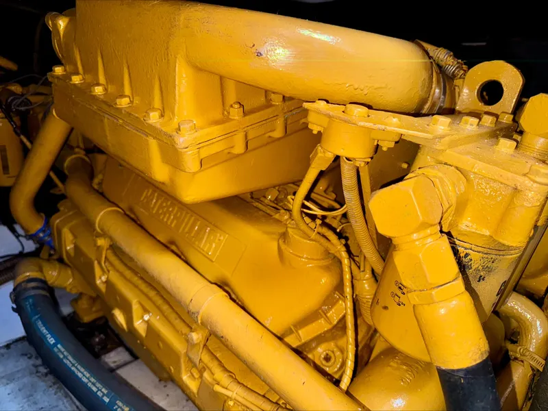 Slide: The Image of Yellow engine of a 1997 Viking Sport Cruisers 48SC boat, detailed view. - 22