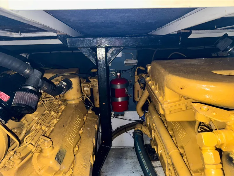 Slide: The Image of Engine room of 1997 Viking Sport Cruisers 48SC with dual engines and fire extinguisher. - 24