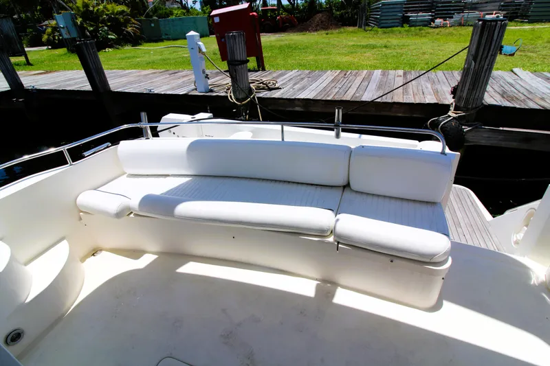 Slide: The Image of ```json
{
"alt_text": "1997 Viking Sport Cruisers 48SC yacht with white seating area."
}
``` - 5