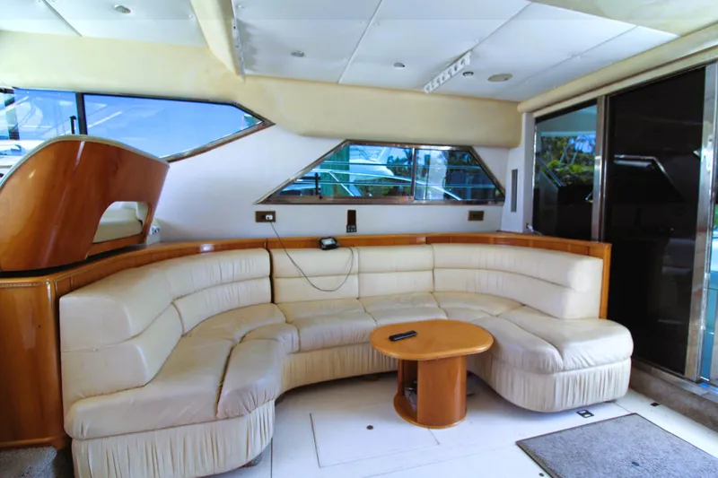 Slide: The Image of Luxurious interior of 1997 Viking Sport Cruisers 48SC with plush seating and wooden accents. - 7