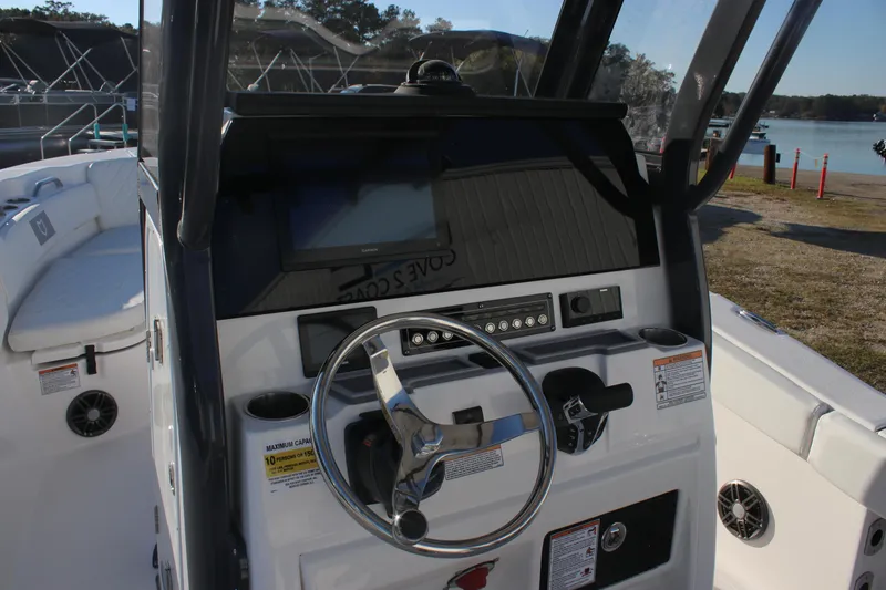 Slide: The Image of 2025 Sea Fox 248 Commander boat dashboard with steering wheel and control panel. - 11