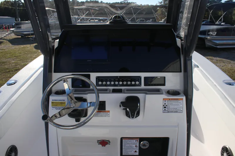 Slide: The Image of 2025 Sea Fox 248 Commander boat dashboard with steering wheel and control panel. - 12
