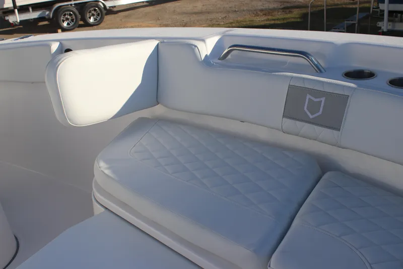 Slide: The Image of 2025 Sea Fox 248 Commander boat interior with cushioned seating and cup holders. - 19