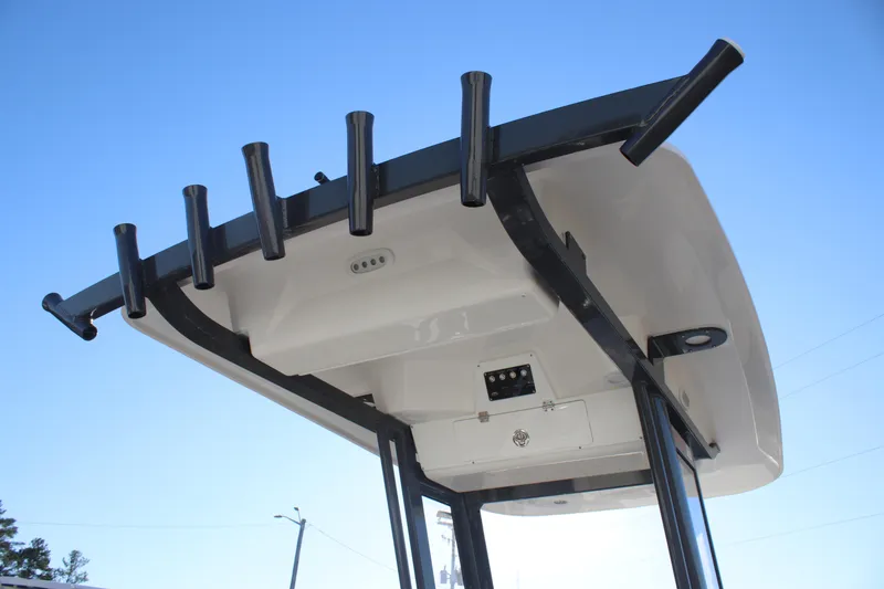 Slide: The Image of 2025 Sea Fox 248 Commander T-top with rod holders against clear sky. - 20