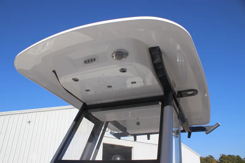 Slide: The Image of 2025 Sea Fox 248 Commander boat's T-top with integrated speakers and lights against blue sky. - 21