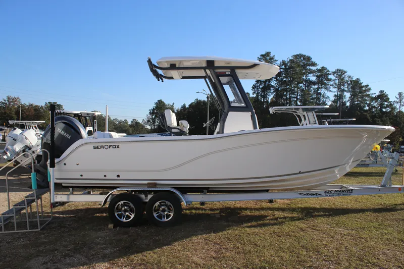 Slide: The Image of 2025 Sea Fox 248 Commander boat on trailer, side view, outdoors. - 6