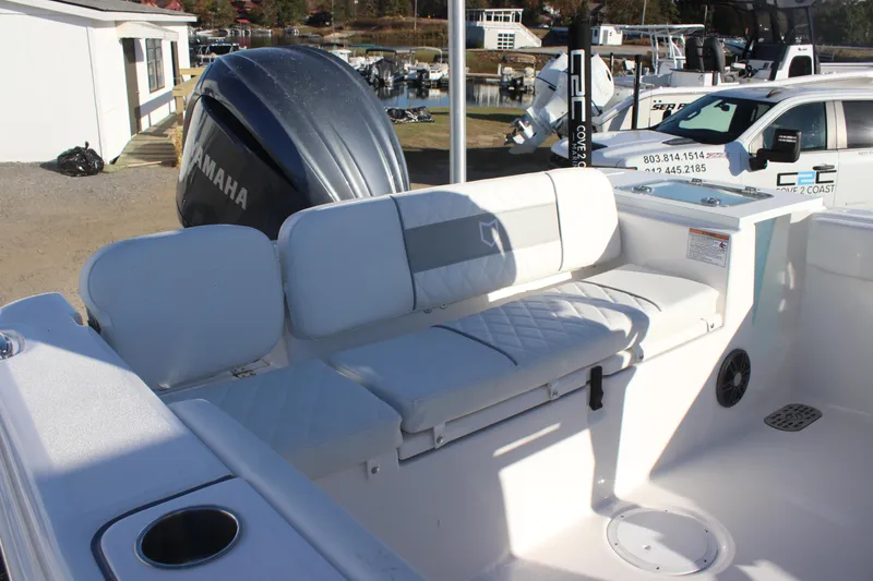 Slide: The Image of 2025 Sea Fox 248 Commander boat interior with Yamaha engine, featuring white seating and cup holder. - 7