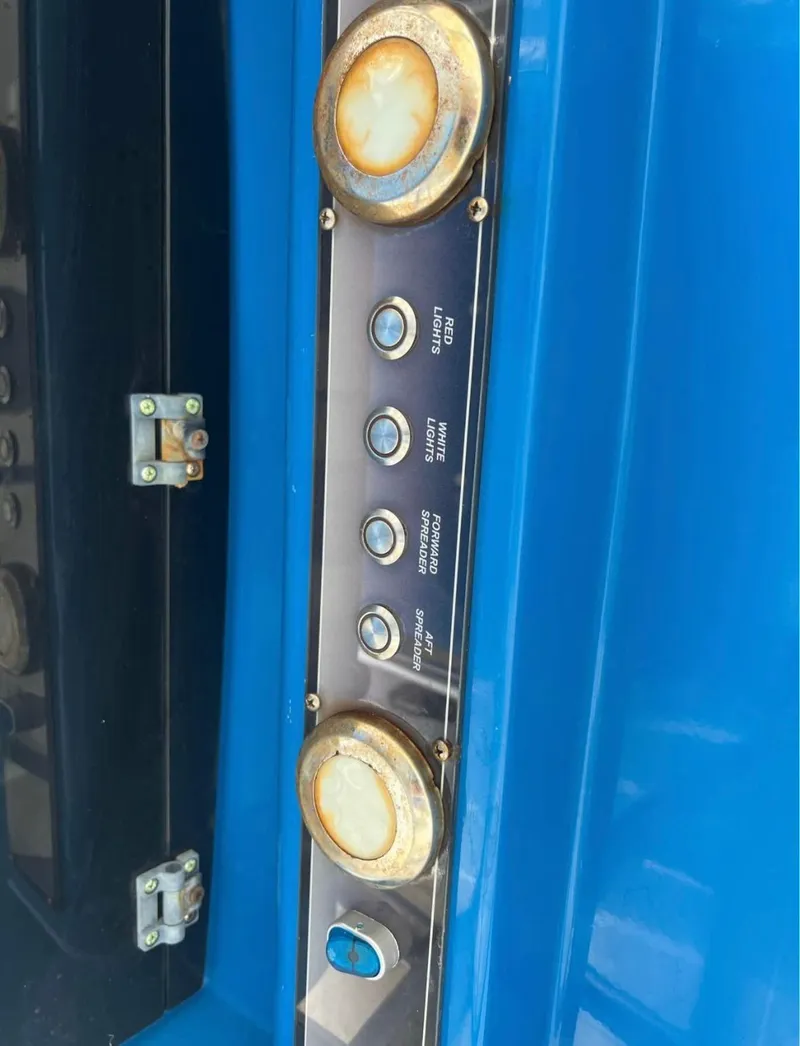 Slide: The Image of Control panel of a 2019 Blue Wave 2800 Pure Bay boat with labeled buttons and switches. - 11