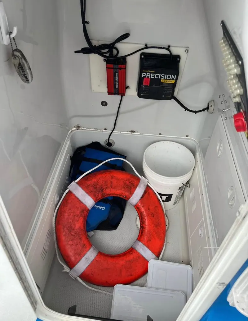 Slide: The Image of Storage compartment of 2019 Blue Wave 2800 Pure Bay with life preserver and equipment. - 12