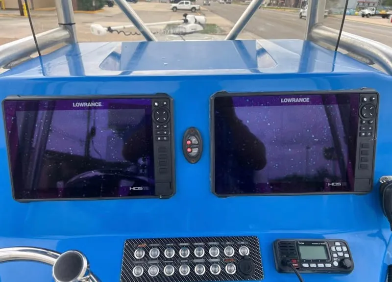 Slide: The Image of 2019 Blue Wave 2800 Pure Bay dashboard with dual Lowrance HDS displays and control panel. - 17