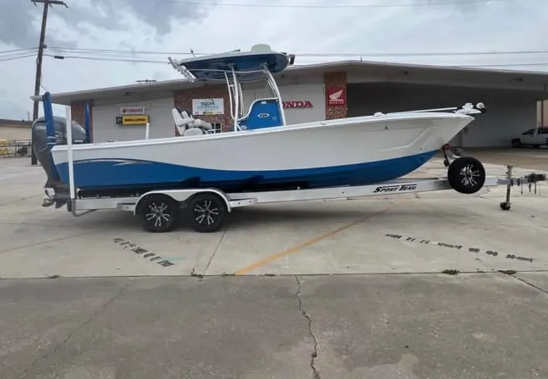 Slide: The Image of 2019 Blue Wave 2800 Pure Bay boat on trailer in parking lot. - 2