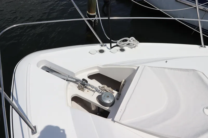 Slide: The Image of 1999 Cruisers Yachts 3750 Motoryacht anchor system on deck, featuring a winch and rope. - 10