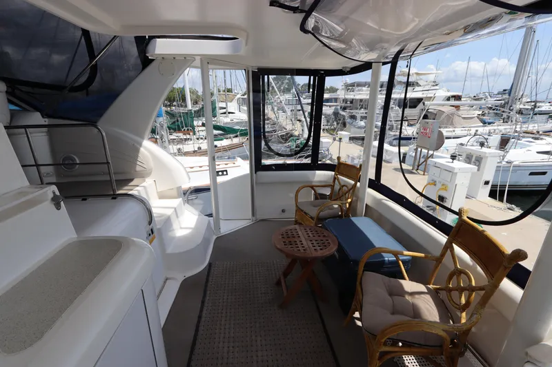 Slide: The Image of 1999 Cruisers Yachts 3750 Motoryacht interior with seating, marina view, and nautical decor. - 12