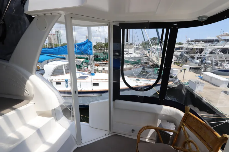 Slide: The Image of 1999 Cruisers Yachts 3750 Motoryacht interior with marina view, featuring seating and windows. - 13