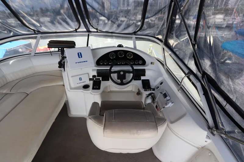 Slide: The Image of 1999 Cruisers Yachts 3750 Motoryacht helm with steering wheel and navigation instruments. - 19