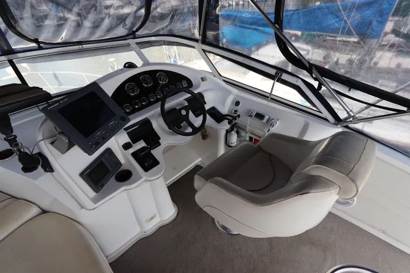 Slide: The Image of 1999 Cruisers Yachts 3750 Motoryacht helm with steering wheel and navigation equipment. - 20