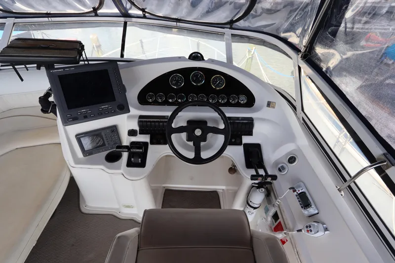Slide: The Image of 1999 Cruisers Yachts 3750 Motoryacht helm with navigation instruments and steering wheel. - 21