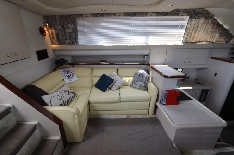Slide: The Image of Interior of 1999 Cruisers Yachts 3750 Motoryacht with beige seating and decorative pillows. - 28