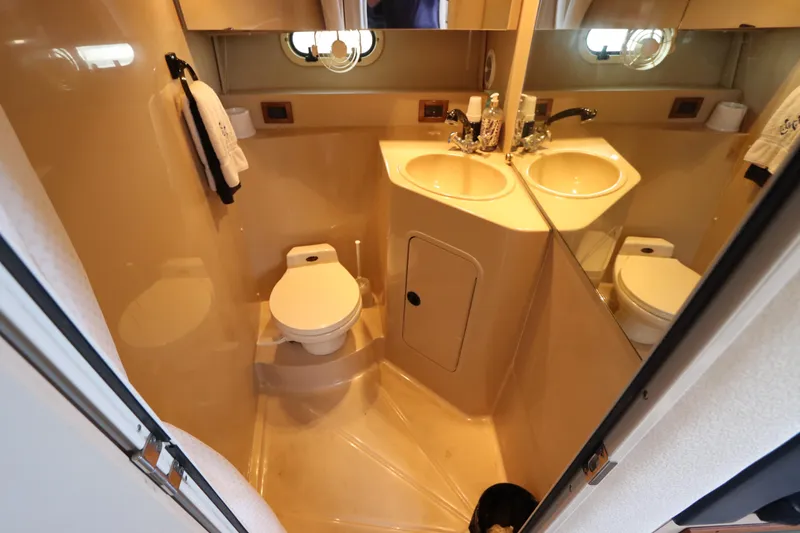 Slide: The Image of 1999 Cruisers Yachts 3750 Motoryacht bathroom with sink, toilet, and mirror. - 37