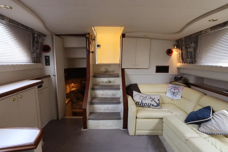 Slide: The Image of 1999 Cruisers Yachts 3750 Motoryacht interior with beige seating and cozy decor. - 41