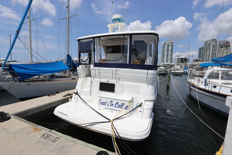 Slide: The Image of 1999 Cruisers Yachts 3750 Motoryacht docked at marina with city skyline. - 5
