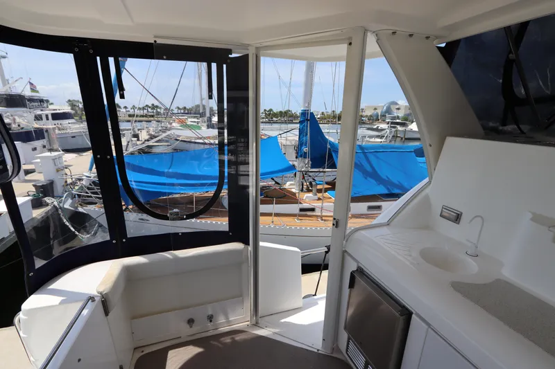 Slide: The Image of 1999 Cruisers Yachts 3750 Motoryacht interior with marina view, featuring sink and seating area. - 15