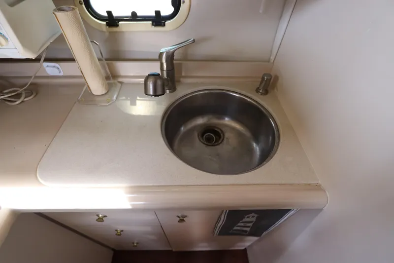 Slide: The Image of 1999 Cruisers Yachts 3750 Motoryacht kitchen sink with faucet and countertop. - 34