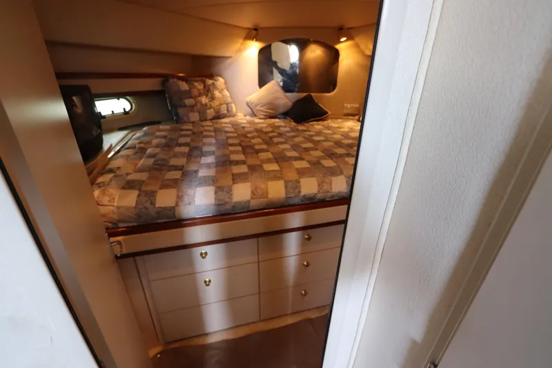 Slide: The Image of 1999 Cruisers Yachts 3750 Motoryacht bedroom with cozy bed and storage drawers. - 38
