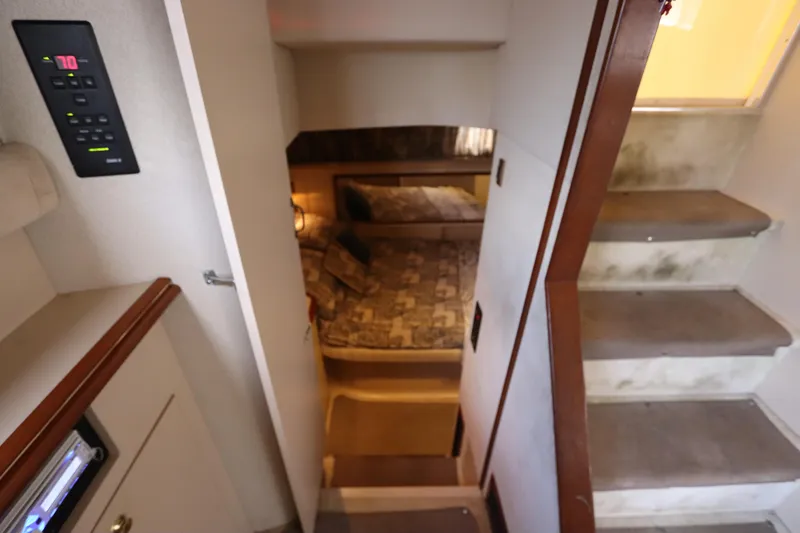 Slide: The Image of 1999 Cruisers Yachts 3750 Motoryacht interior with stairs and cozy bedroom. - 42
