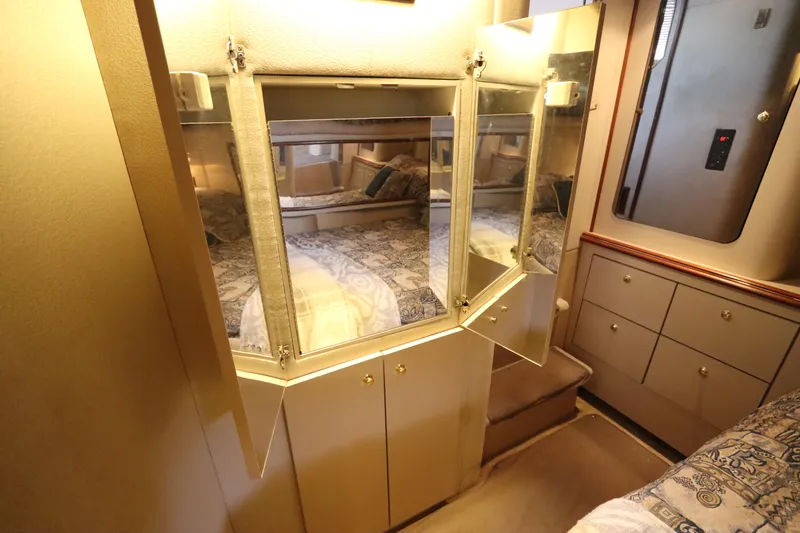 Slide: The Image of 1999 Cruisers Yachts 3750 Motoryacht interior with mirrored cabinets and cozy bedding. - 45