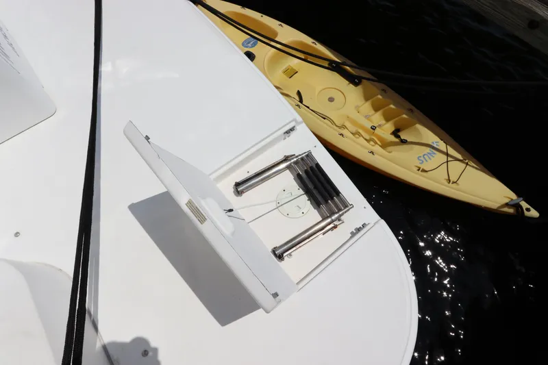Slide: The Image of 1999 Cruisers Yachts 3750 Motoryacht with kayak and retractable ladder on deck. - 7