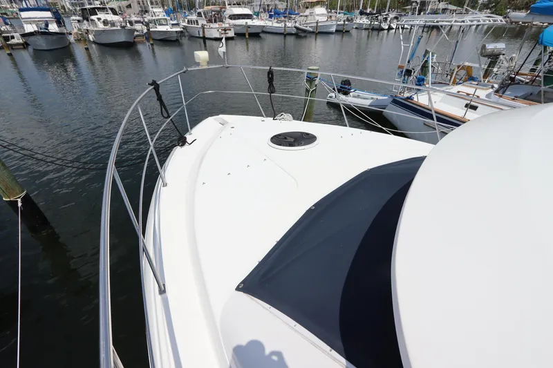 Slide: The Image of 1999 Cruisers Yachts 3750 Motoryacht docked at a marina, view of the bow area. - 9