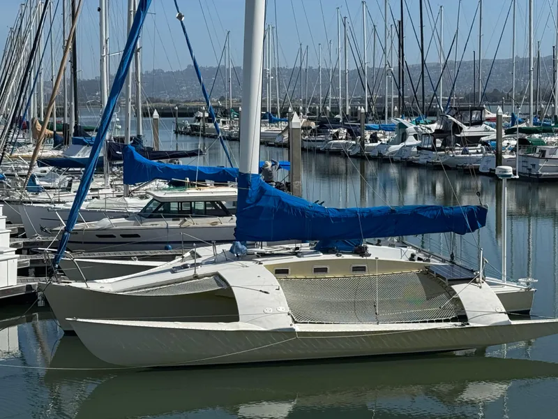 Slide: The Image of 1982 Greene Marine 35 Acapella sailboat docked in a marina with blue covers. - 1