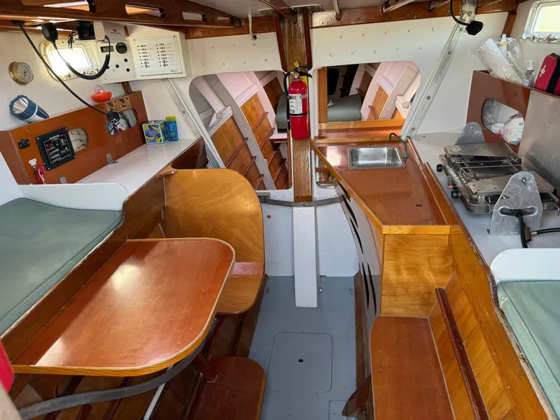 Slide: The Image of Interior of 1982 Greene Marine 35 Acapella sailboat with wooden furnishings and compact kitchen. - 2