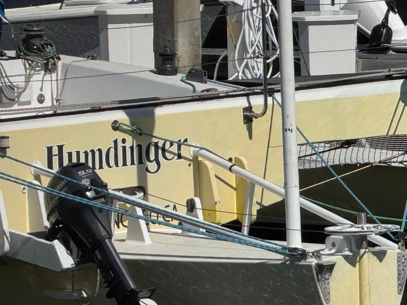 Slide: The Image of 1982 Greene Marine 35 Acapella boat named "Humdinger" docked with visible outboard motor. - 3