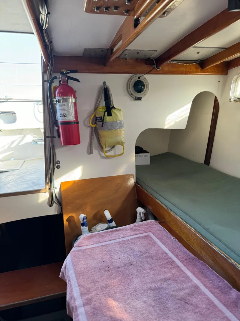 Slide: The Image of Interior of 1982 Greene Marine 35 Acapella boat with bunk, fire extinguisher, and life jacket. - 6