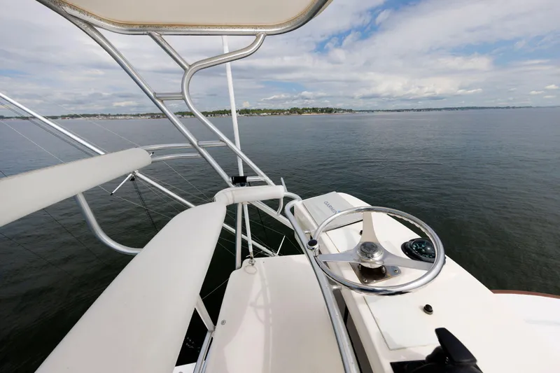 Slide: The Image of 2002 Albemarle 41 Express Fisherman helm view on calm waters. - 16
