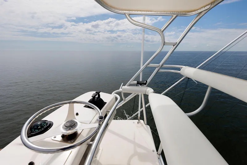 Slide: The Image of Helm of 2002 Albemarle 41 Express Fisherman overlooking calm ocean waters. - 17