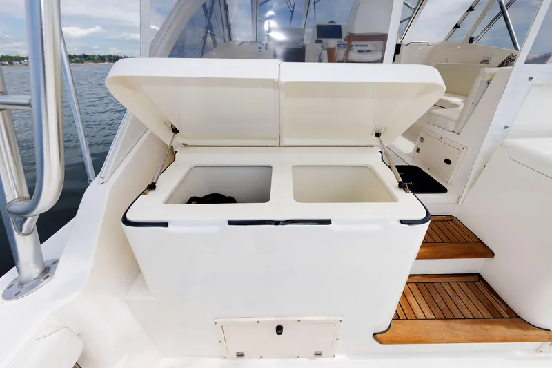 Slide: The Image of 2002 Albemarle 41 Express Fisherman boat with open storage compartment on deck. - 21