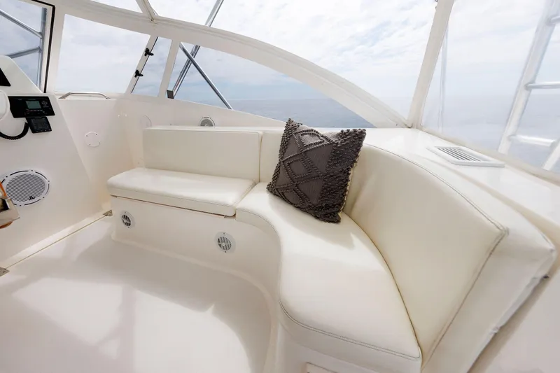 Slide: The Image of 2002 Albemarle 41 Express Fisherman interior with white seating and decorative pillow. - 24