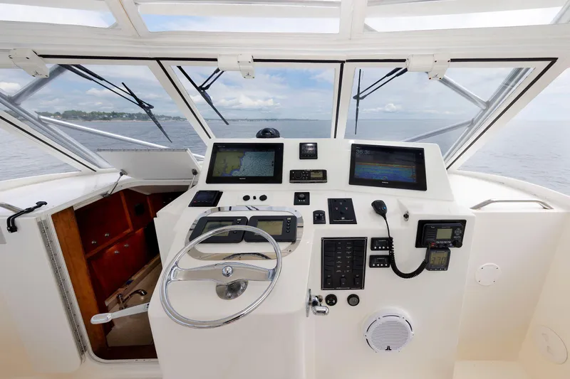 Slide: The Image of Helm of 2002 Albemarle 41 Express Fisherman with navigation equipment and steering wheel. - 25