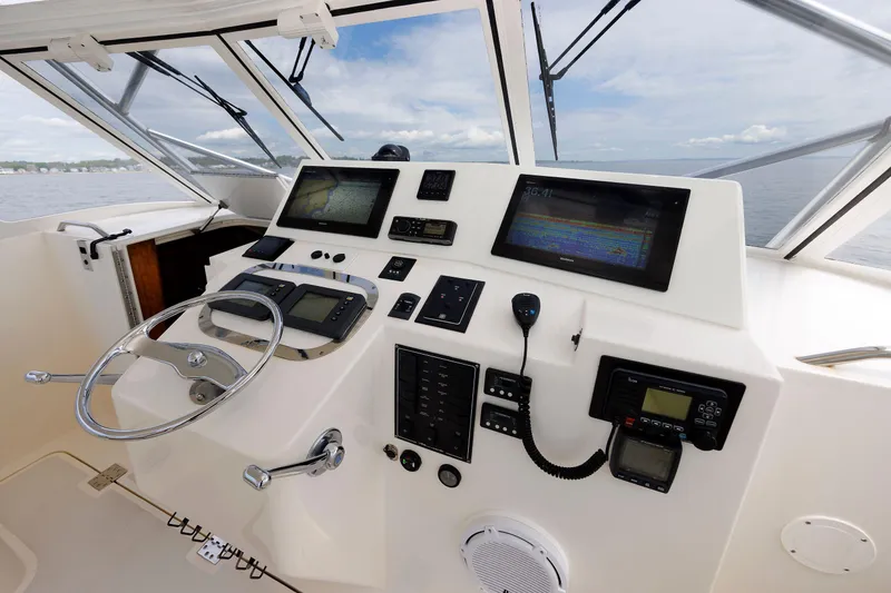Slide: The Image of 2002 Albemarle 41 Express Fisherman helm with navigation equipment and steering wheel. - 26
