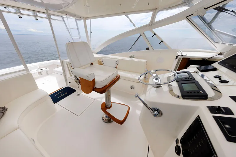 Slide: The Image of 2002 Albemarle 41 Express Fisherman boat interior with captain's chair and control panel. - 27